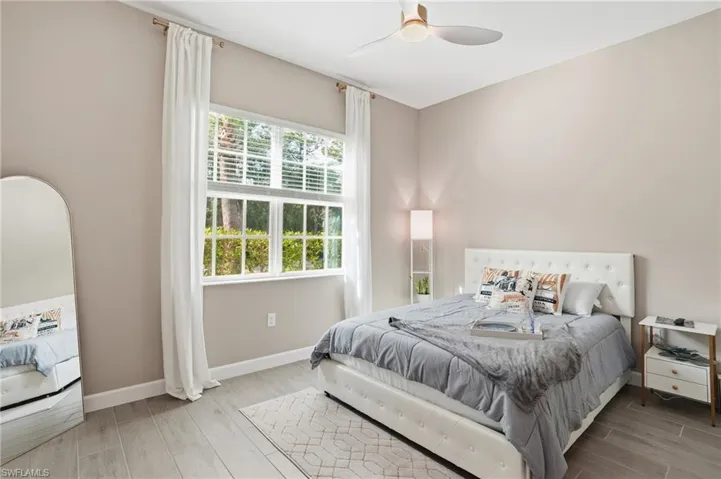Bedroom with wood finish floors and ceiling fan