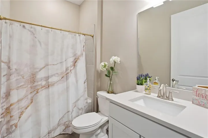 Full bathroom featuring vanity and shower / bathtub combination with curtain