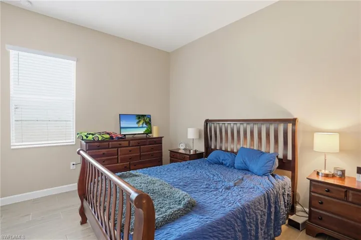 Bedroom with baseboards and wood tiled floors