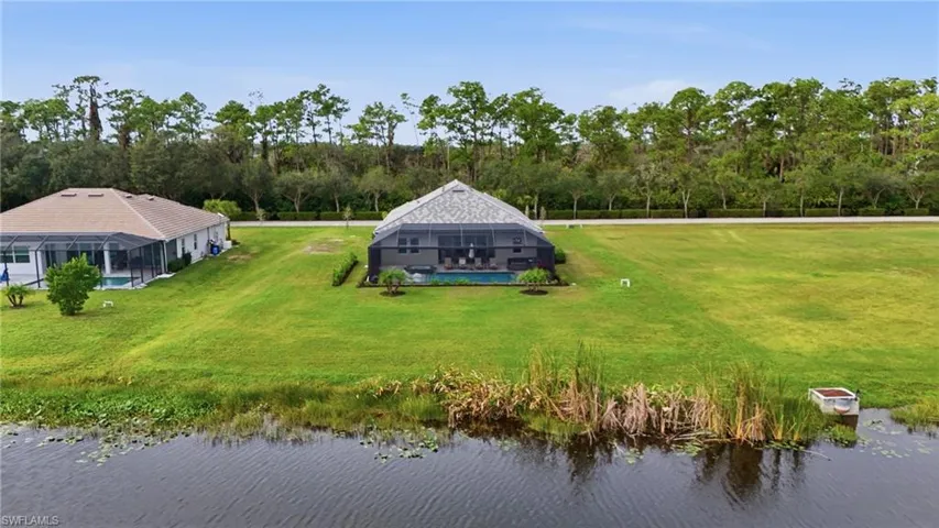 Aerial view of property and surrounding area featuring a large body of water
