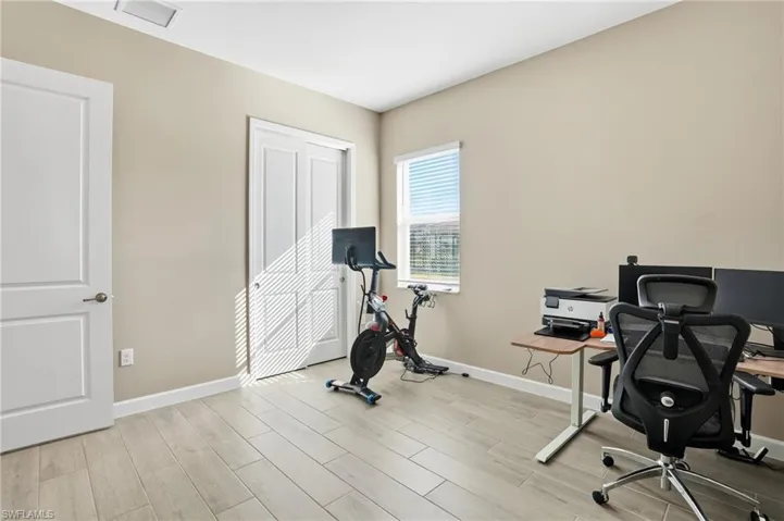 Office with wood finish floors and baseboards