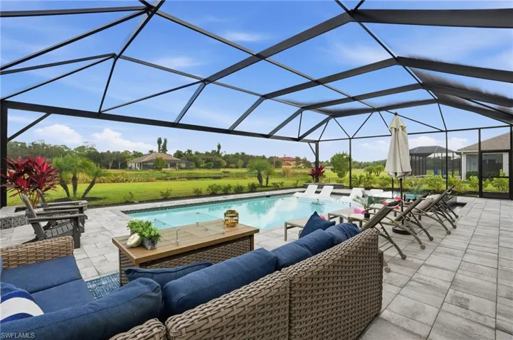 Outdoor pool with a lanai, a sunroom, outdoor lounge area, and a patio area