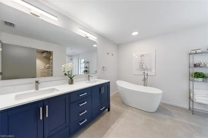 Bathroom featuring a bath and vanity