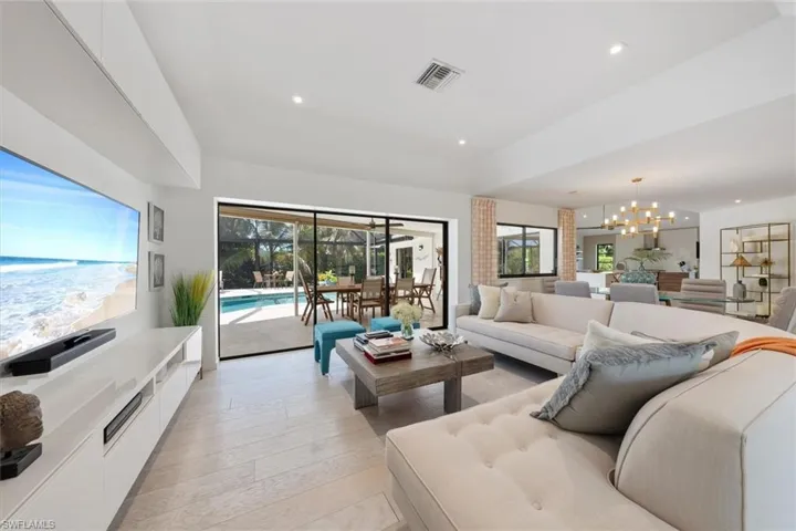 Living room featuring an inviting chandelier and light hardwood / wood-style flooring