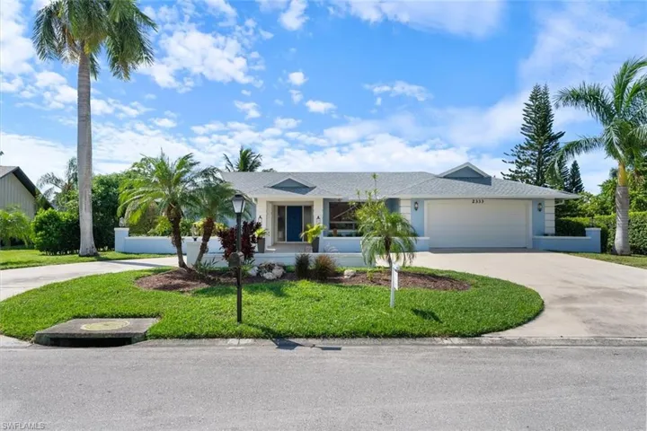 Single story home featuring a front lawn and a garage