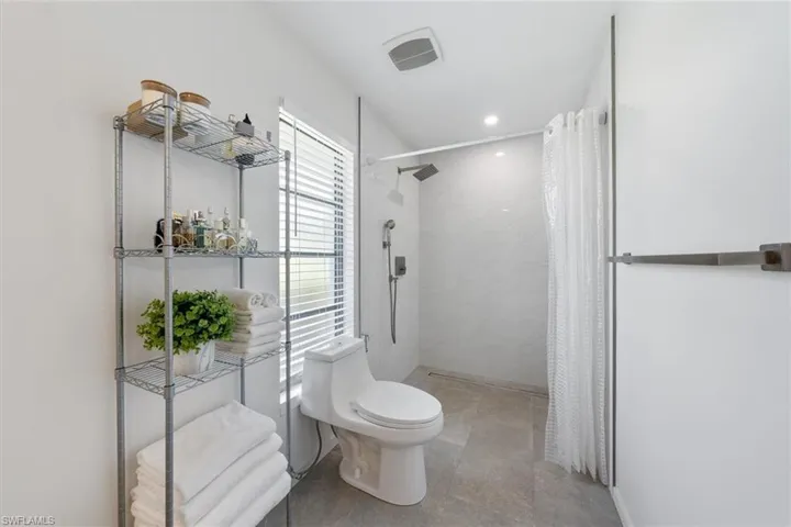 Bathroom with toilet and a shower with curtain