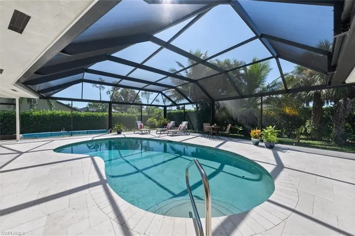 View of swimming pool featuring a lanai and a patio area