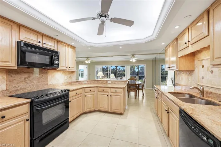The kitchen offers ample storage and classic finishes.