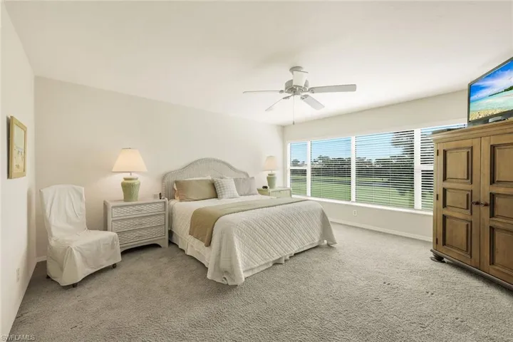 A tranquil primary suite overlooking the greens - perfect for recharging after a  day of Florida sunshine.