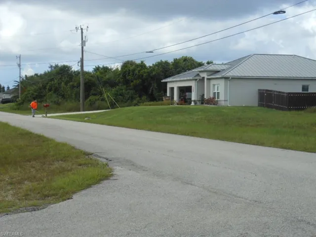 View of asphalt road with street lights and traffic signs