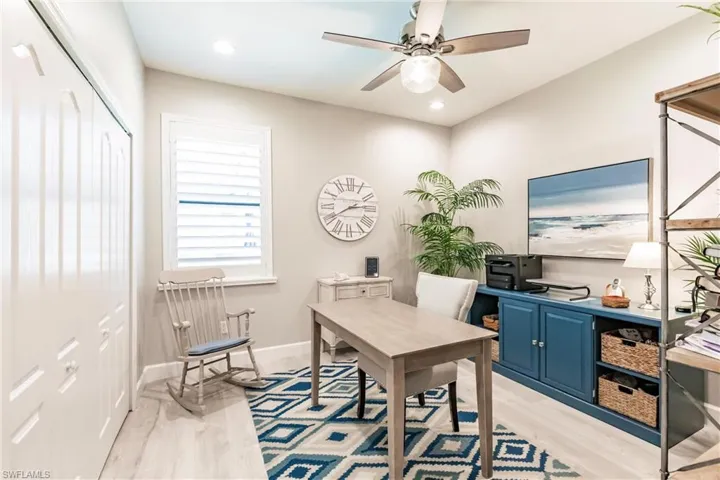 Office area with ceiling fan and light hardwood / wood-style floors