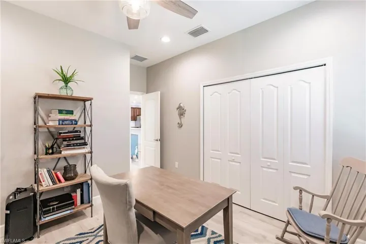 Office space featuring ceiling fan and light hardwood / wood-style floors