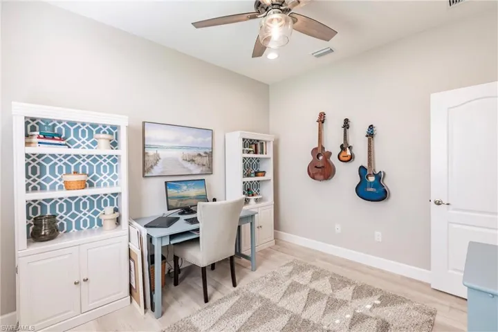 Office area with light hardwood / wood-style flooring and ceiling fan