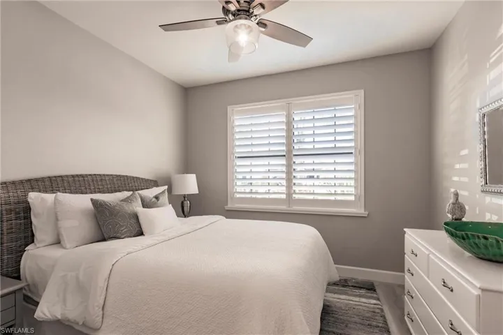 Bedroom with hardwood / wood-style flooring and ceiling fan