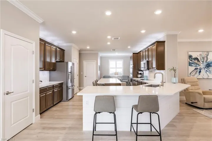 Kitchen featuring appliances with stainless steel finishes, sink, light hardwood / wood-style floors, and kitchen peninsula