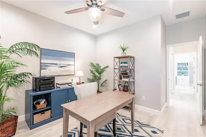 Home office featuring ceiling fan and light wood-type flooring