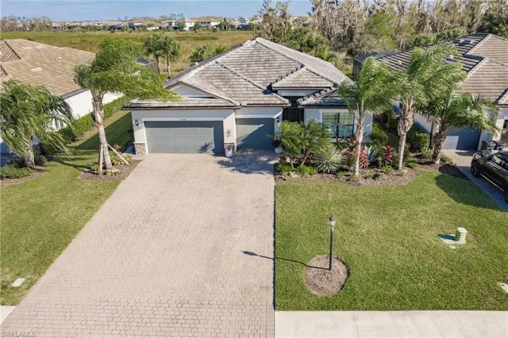 Ranch-style home featuring a garage and a front yard