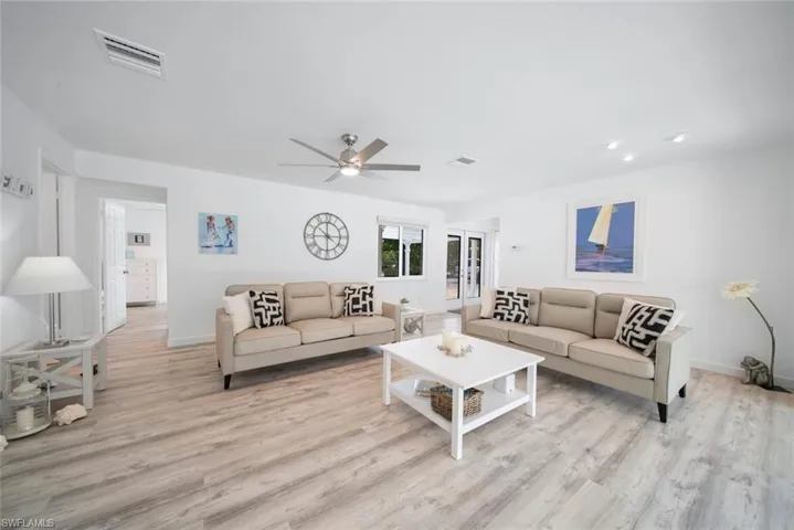 Open-concept interior featuring wood-finish flooring, recessed lighting, and a ceiling fan