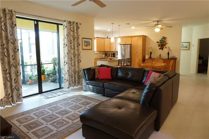 Living area with ceiling fan, recessed lighting, and light wood plank LVP flooring