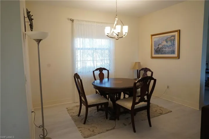 Dining space featuring light wood plank LVP flooring and a chandelier