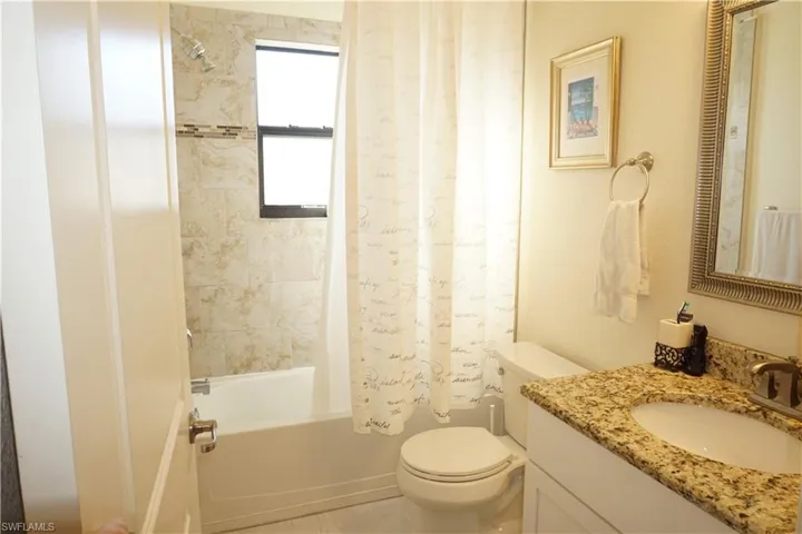 Guest bathroom with shower / bath combo and vanity