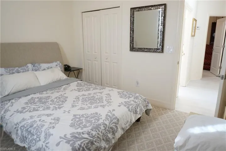 Bedroom with a closet and light colored carpet