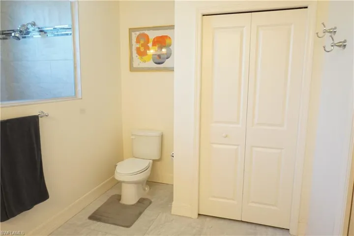Primary Bathroom featuring a closet and tile patterned flooring