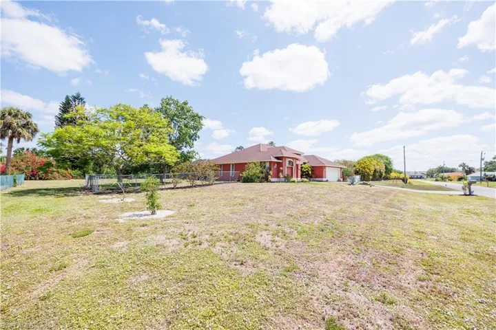 View of yard with a garage and fence