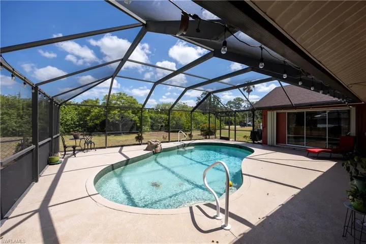 Outdoor pool featuring a lanai and a patio area