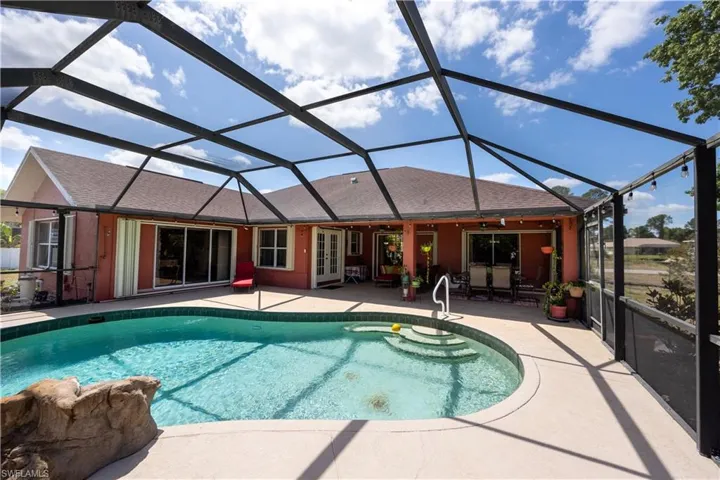 Pool with a patio, french doors, and a lanai