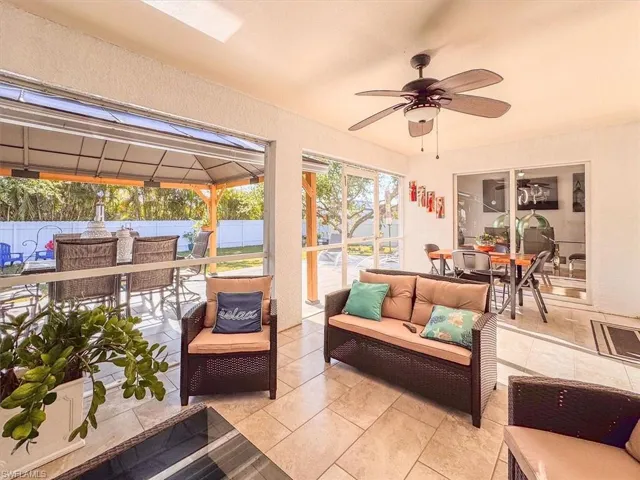 View of patio with an outdoor hangout area, ceiling fan, outdoor dining area, and fence