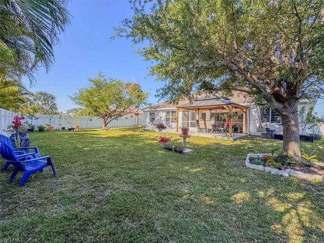 View of yard featuring a fenced backyard, a gazebo, and a patio area