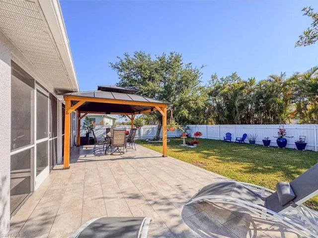 View of patio / terrace featuring a fenced backyard, a gazebo, and outdoor dining space