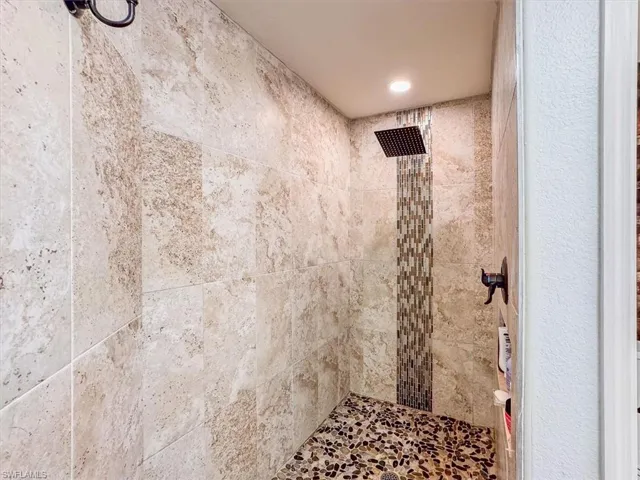 Full bath featuring a tile shower