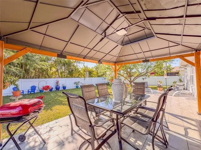 View of patio / terrace with area for grilling, a fenced backyard, outdoor dining area, and a gazebo