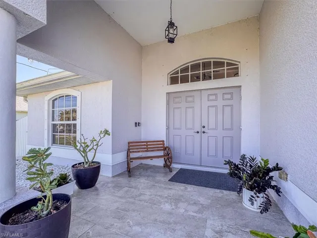 Doorway to property with stucco siding