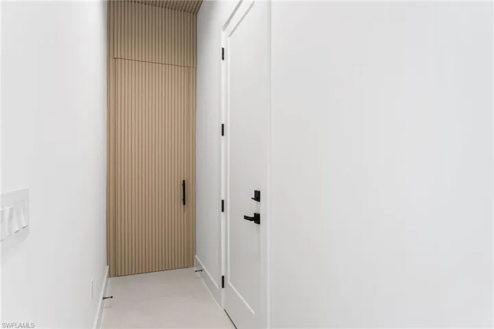 CONCEALED LAUNDRY w/ ACOUSTIC PANELING door & in the entrance hallway