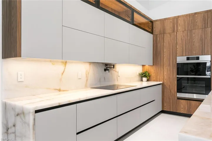 Top-of-the-line CABINETRY, under- & top-cabinet lighting, CRISTALLO QUARTZITE countertops, full backsplash & POT FILLER.