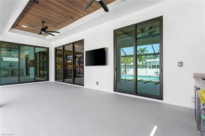 PATIO EQUIPPED w/ designer fan, FLAT WOODEN CEILING, BOSE SURROUND SOUND SYSTEM & 75" TV, IDEAL for GATHERINGS! Impact-resistant windows to the primary bedroom, living room & formal dining room.