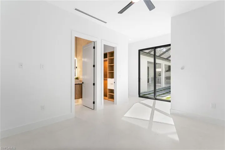 Spacious second master bedroom with custom cabinet closets.