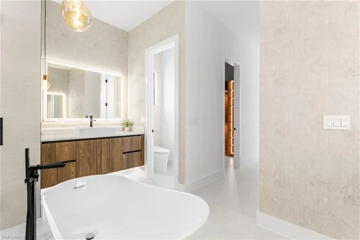 LUXURIOUS PRIMARY BATH w/ STANDALONE TUB & custom vanities w/ VESSEL SINKS, an indulgent SPA ATMOSPHERE!