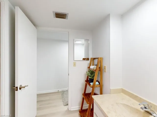 Bathroom featuring hardwood / wood-style flooring and vanity