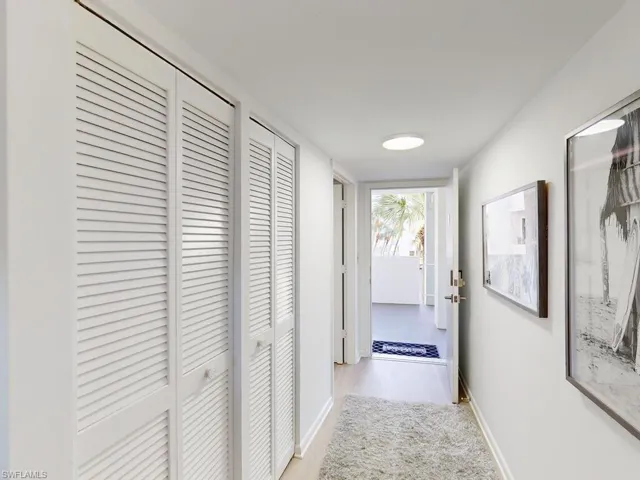 Hall with light hardwood / wood-style floors