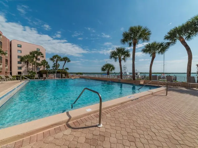 View of swimming pool featuring a patio area and a water view