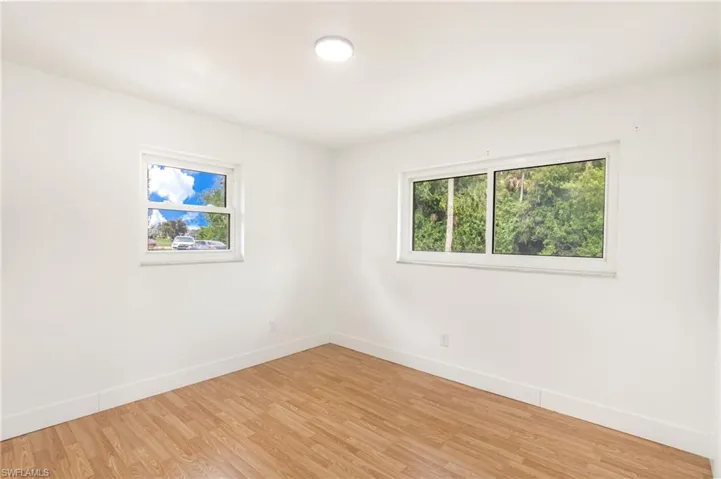 Room featuring light wood-finish flooring and white baseboards