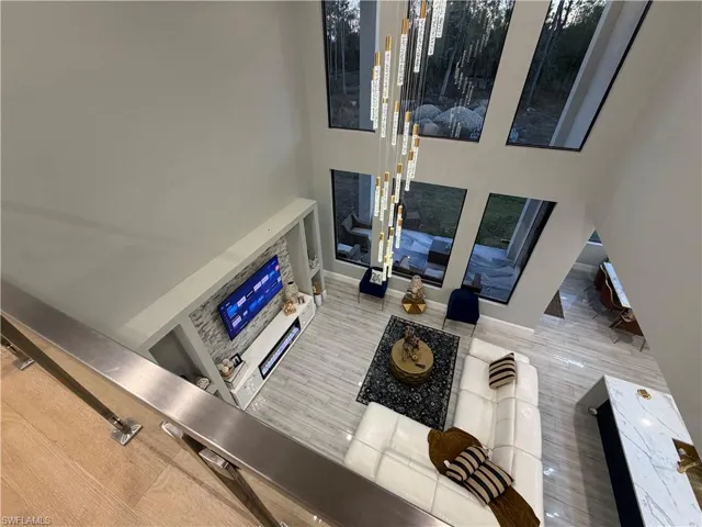 Living room with a high ceiling and baseboards