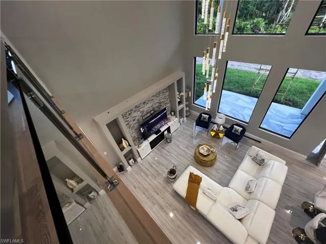 Living area featuring a high ceiling and a fireplace