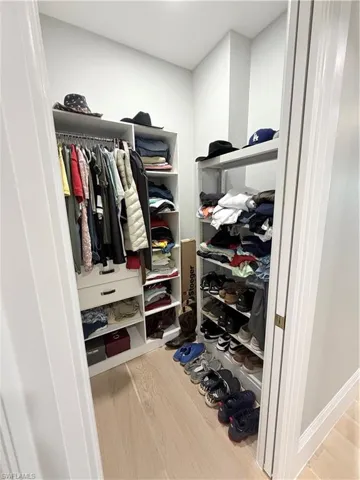 Walk in closet featuring light wood finished floors