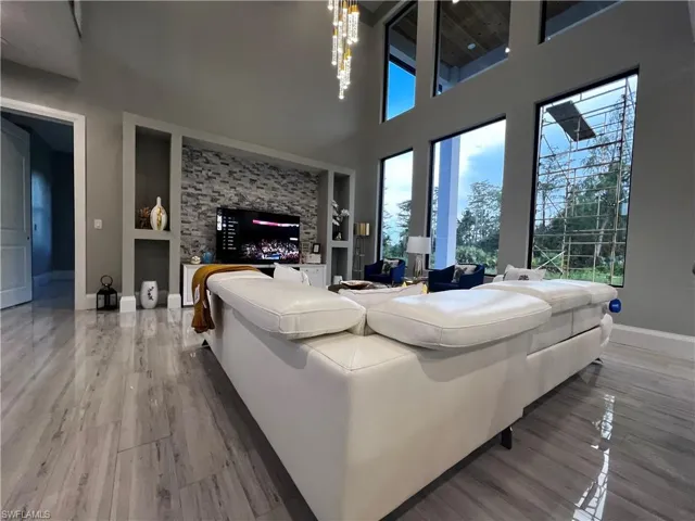 Living room featuring built in features and a high ceiling