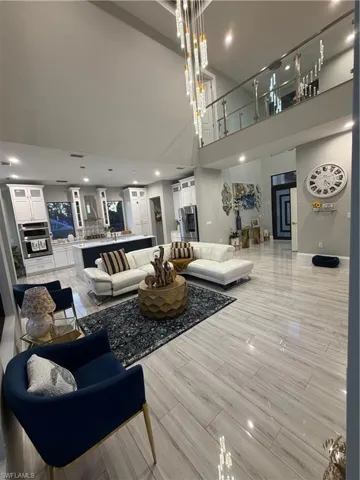 Living room featuring recessed lighting and a towering ceiling